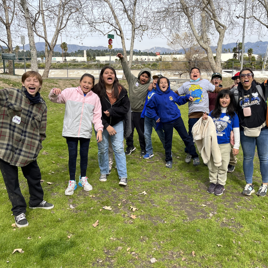 Students pose for a silly picture outdoors.